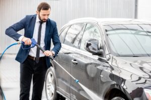 Businessman washing his car